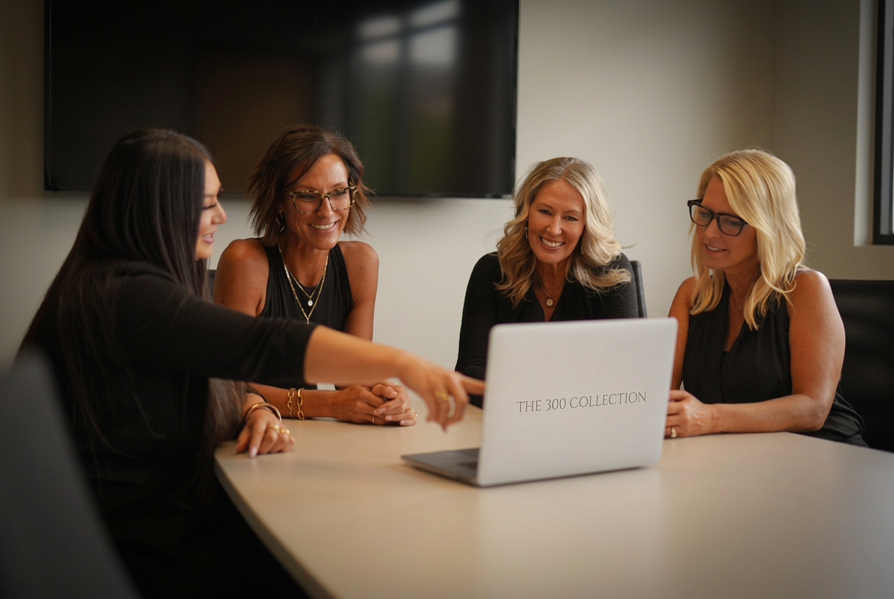 Four members of The 300 Collection collaborating around a conference table